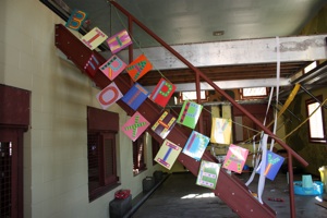 Happy Birthday Foxie sign hung on stairs in playroom