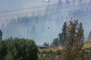 helicopter dropping water near building
